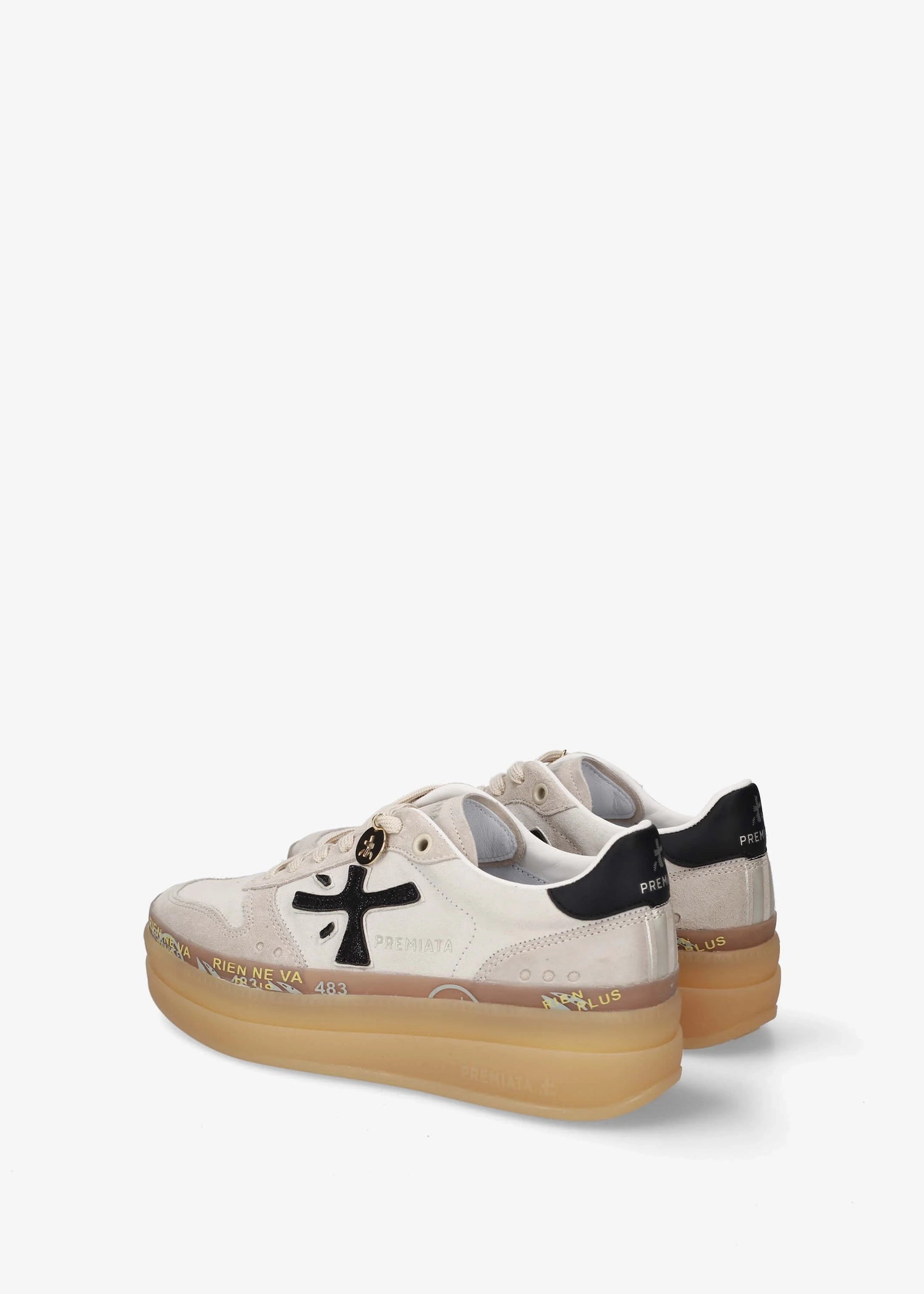 A low-top platform sneaker by Premiata, featuring a cream and beige suede and mesh upper, a black cross logo on the side, gold-tone hardware, and a thick tan gum sole.